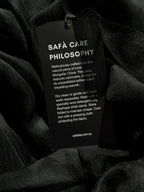 Black cashmere fabric with a Safà Boutique care tag
